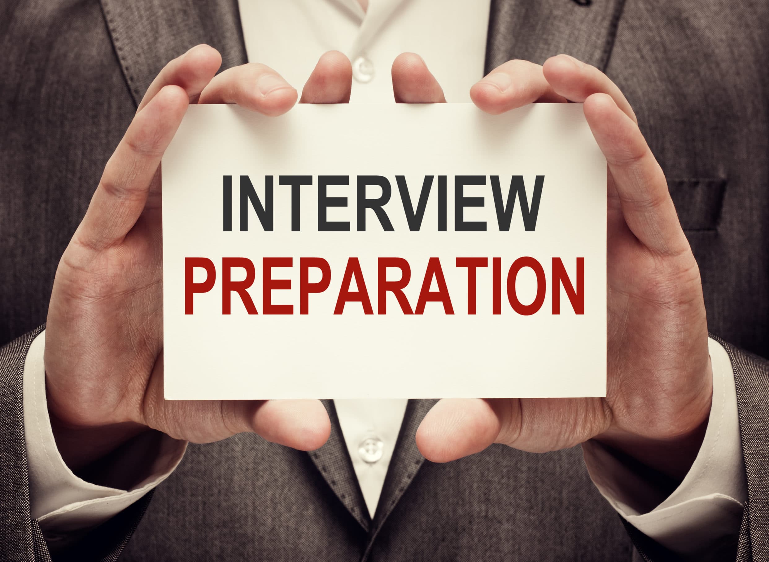 Professional holding interview preparation guide card